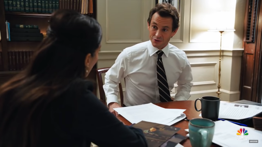 man in a white shirt sitting at the table and looking at the woman in front of him