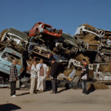 five breaking bad characters standing on the car dump