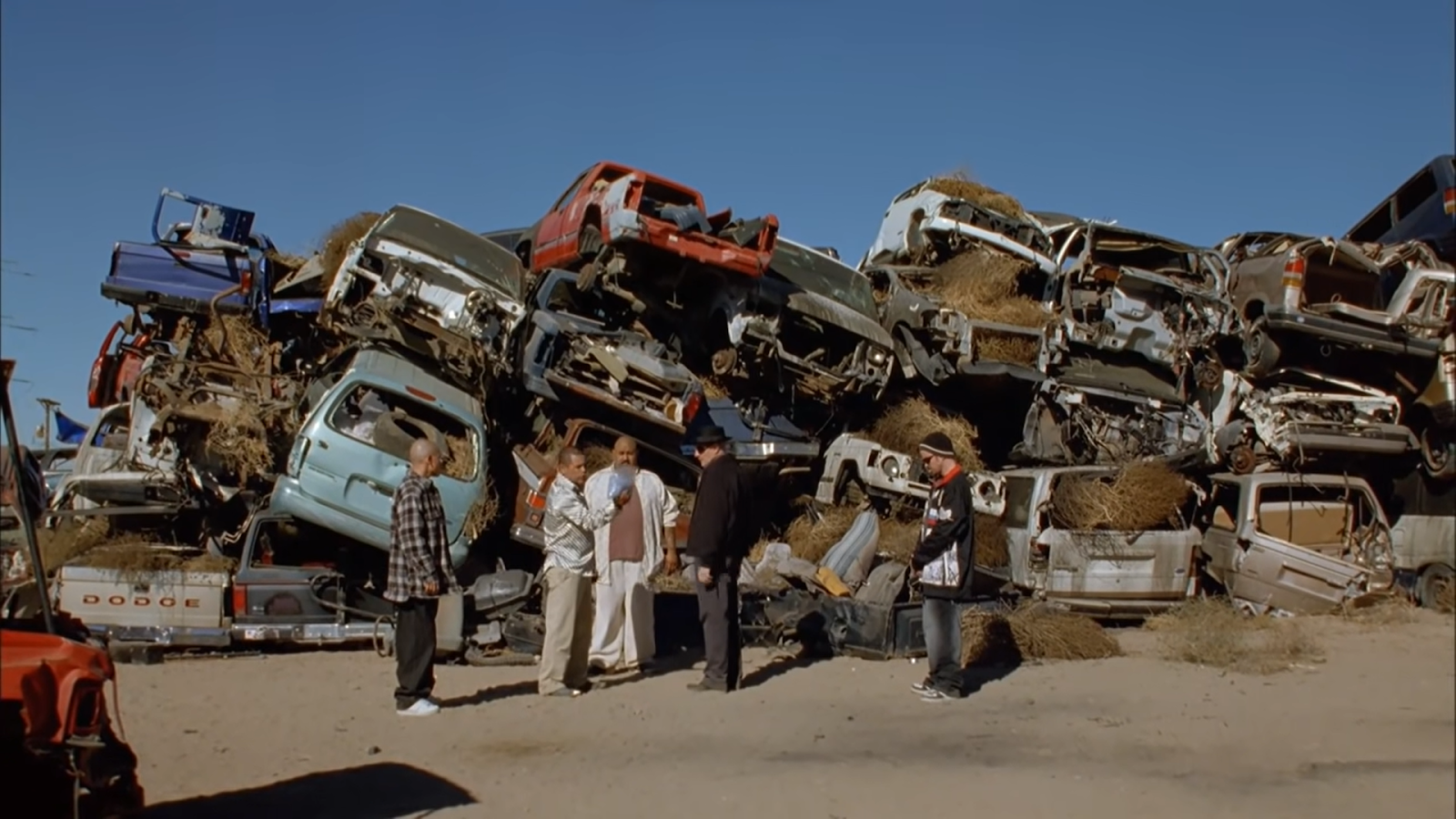 five breaking bad characters standing on the car dump